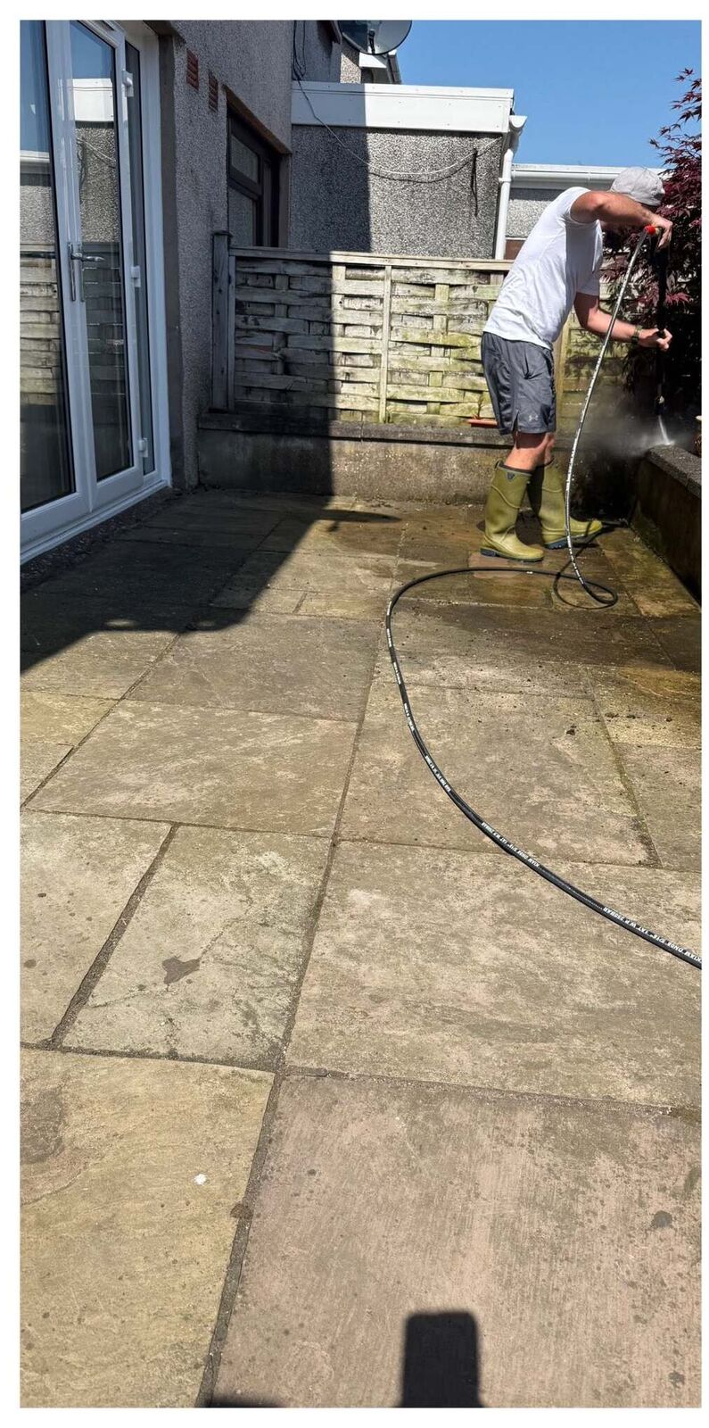 Patio covered in grime being pressure washed
